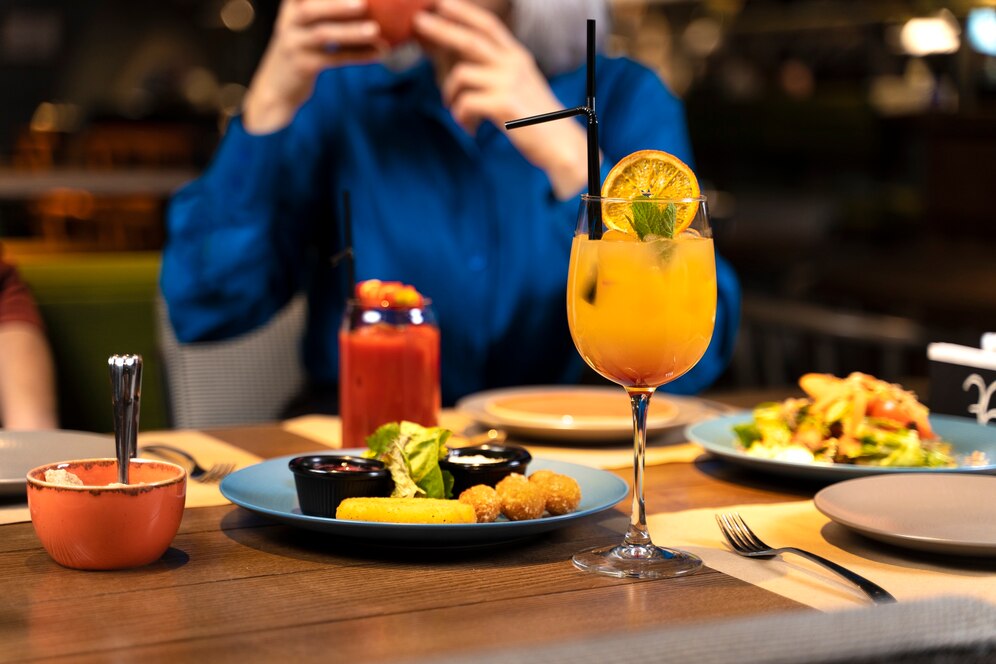 senior-woman-taking-photo-food-drinks-restaurant_23-2149316750