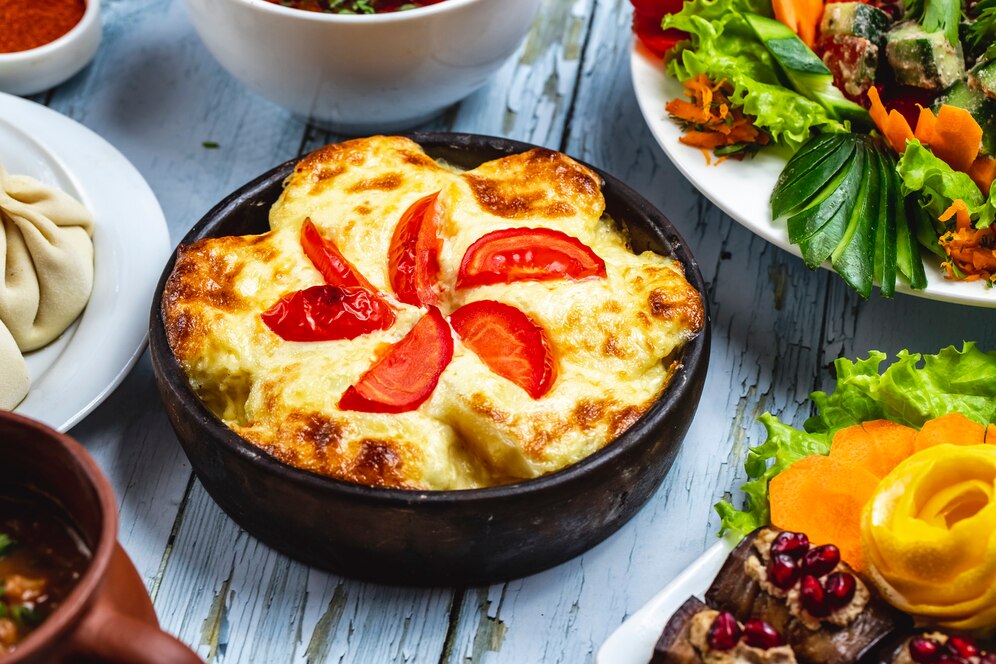 side-view-casserole-with-potato-cheese-tomato-clay-dish_141793-4802